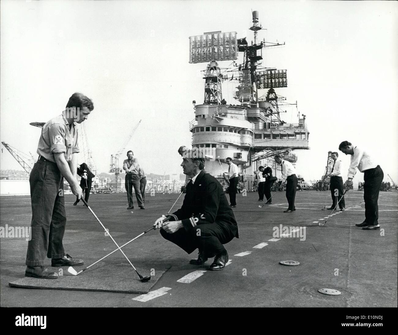 Aug. 08, 1973 - Golf on the Ark Royal: Officers in Ark Royl, the Navy's Largest aircraft carrier now in Devonport for a six-months refit, refused to admit defeat when ratings wanting to learn to play golf asked them to help. Nets were rigged to allow driving practise and back in port the flight-deck became a practice ''green''. The craze for golf swept the lower deck after programmes on the British Open were televised during the carrier's recent Commission Stock Photo
