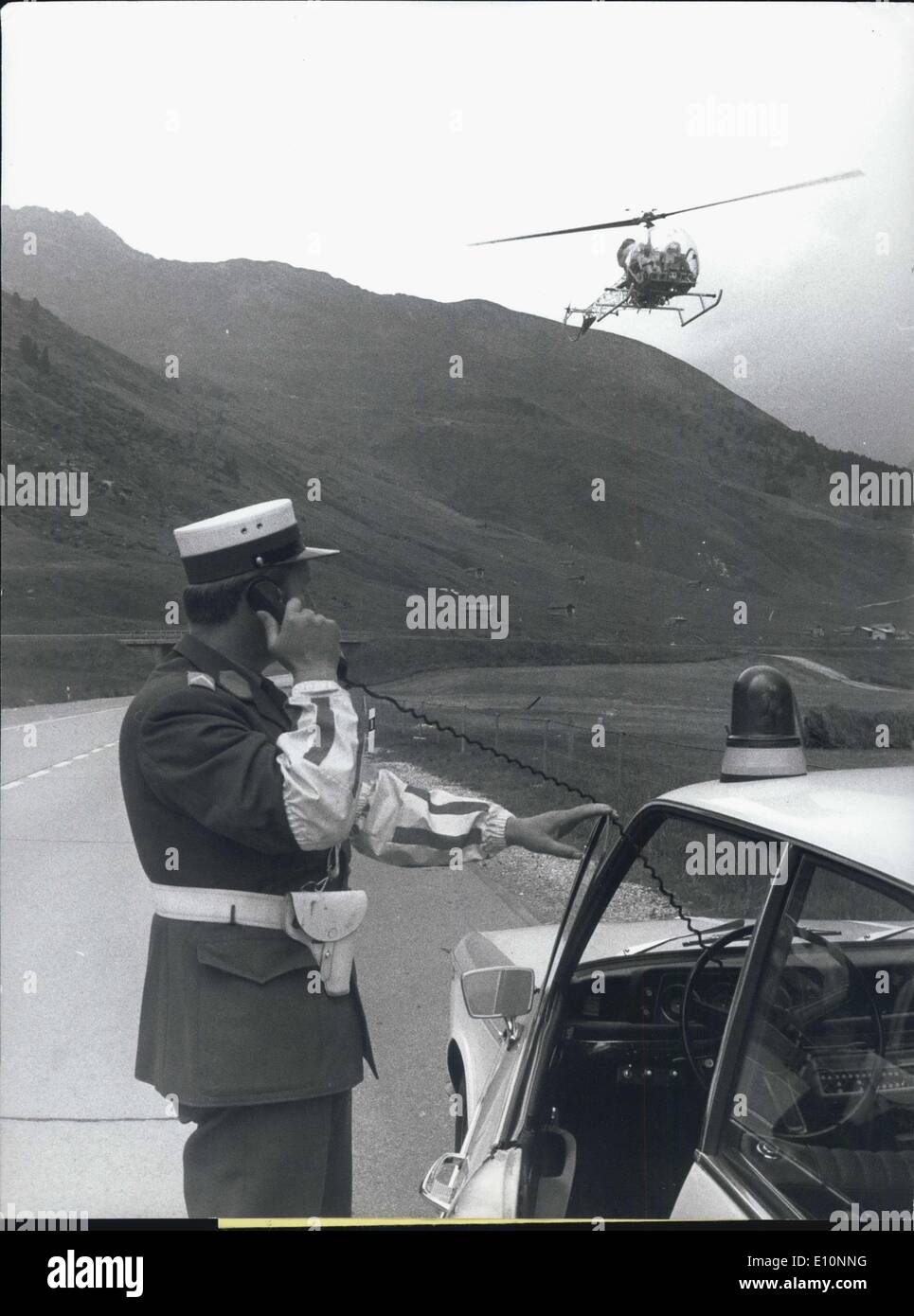 Aug. 20, 1973 - Police Highway-Patrol With Helicopter: It is not new, the idea of controlling highway traffic from the sky. Even in Switzerland several helicopters already are in service of the highway-police. But now the Canton of Graubunden is preparing a helicopter service for is streets, especially for the San Bernardino-Pass-Street, where up to one thousand cars pass in one hour at the holiday-rushhours. Photo shows the street-patrol calls the helicopter by telephone. A good coordination of groundstation and the helicopter is necessary for good functioning of the air-patrol. Stock Photo