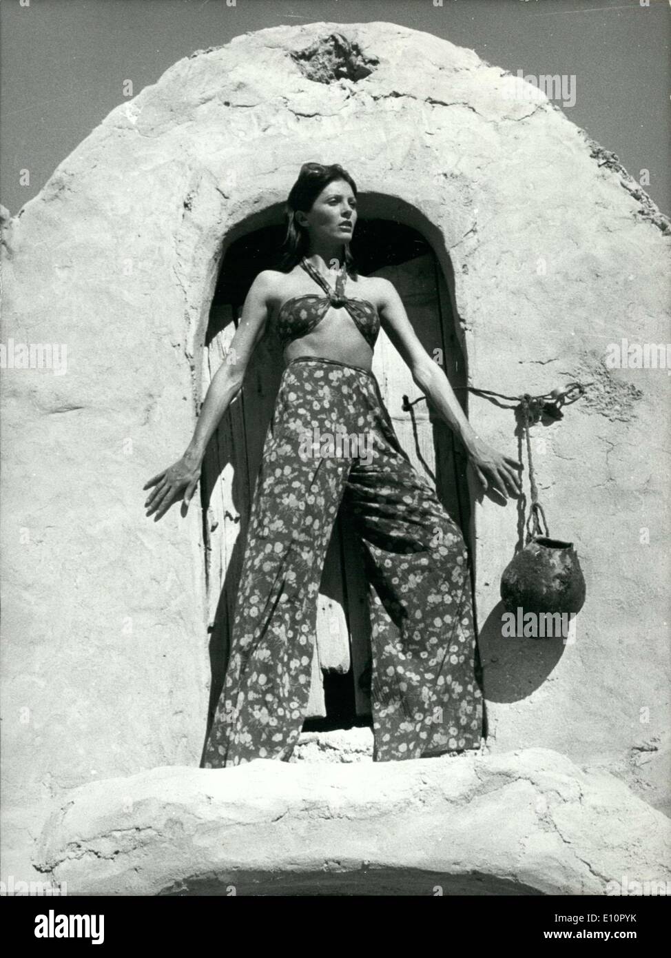 Oct. 04, 1973 - The organizers of a ready-to-wear fashion show chose South Tunisia as their backdrop for presenting some feminine styles. Here is a creation by Fernand Ledoux presented with a sunny oasis in the background. The pant-skirt is in floral-printed crepe (yellow and apricot flowers on a chocolate background). The top is closed by an orange buckle. Stock Photo