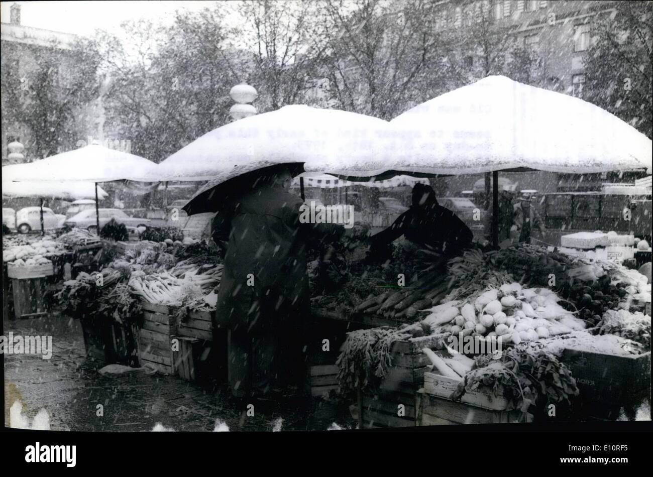 Oct. 10, 1973 - This year's first fall of snow in Munich Old man winter... seems to appear kind of early this year, actually to-day on Oct. 18th, 1973. It was quite a heavy snowfall, but naturally - and fortunately the snow did not stay. Let's hope this is not a sign of a very early beginning of the wintery season, after all this is still the first month of autumn only. Ops. View at the big umbrellas of the Victualienmarkt, Munich's green grocery market, which were quickly covered heavily by white snow. Stock Photo