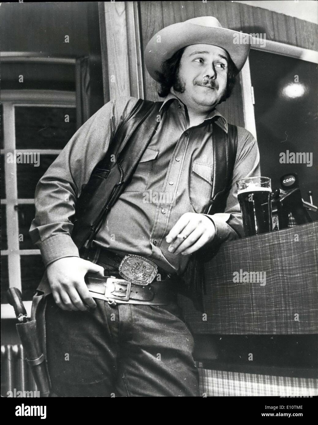 Mar. 12, 1974 - Big John's in Town. Everybody in the town knows Big John. With his colt 45, station hat and silver spus he looks like a character strength out of the old wild west. He can be seen most week -ends having a few beers in the local saloon. the British legion club at wigton (Cumberland). For 23-year old john Graham is a cowboy fanatic. And he likes to look the part when he has a night out. He said ''I've always been very keen on cowboys and I never miss a western on television. ''I bought a station three years ago and one thing led to another Stock Photo