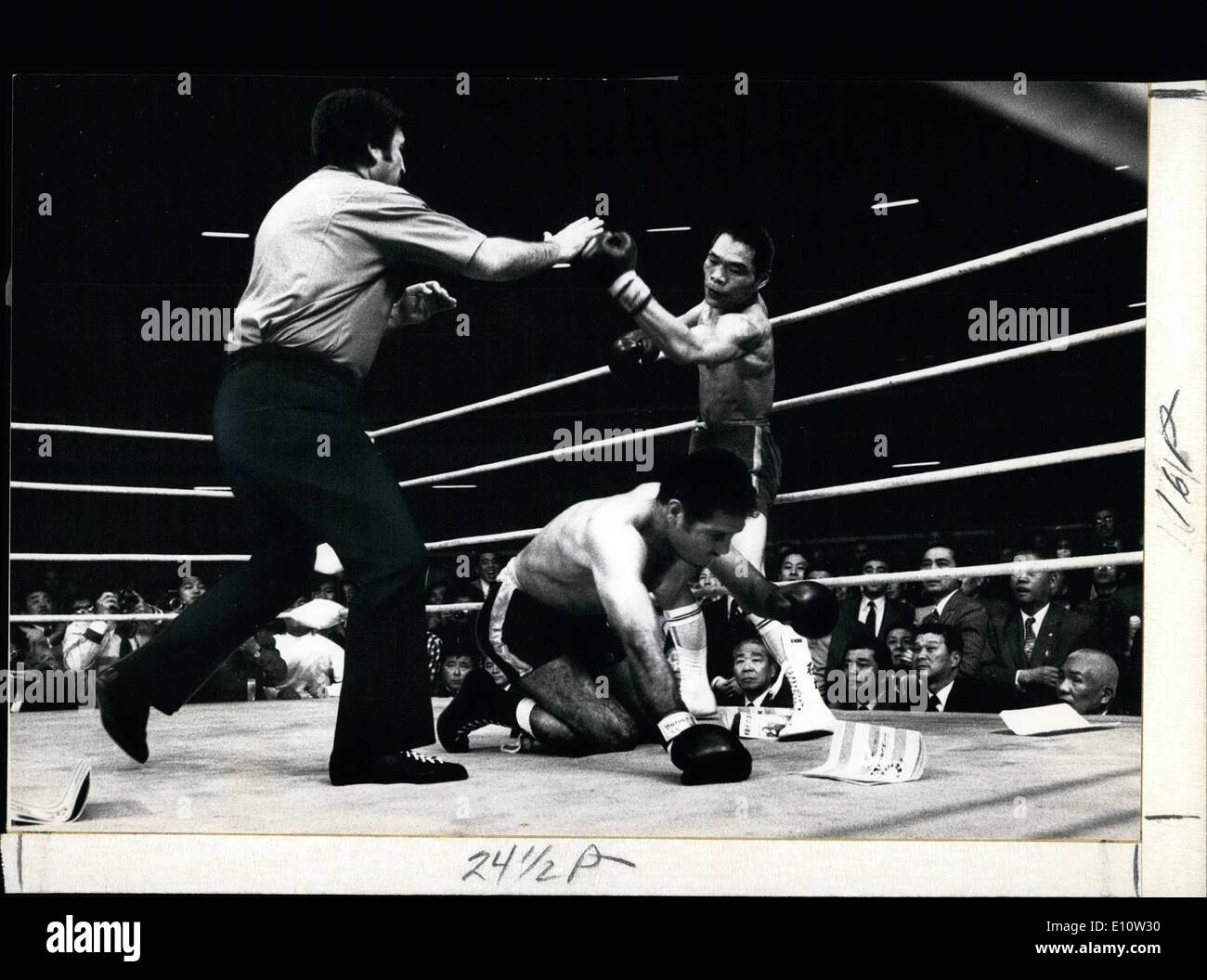 Apr. 04, 1974 - Challenger Wins World Title with Knock-Out in Japan: The referee steps forward to stop Japanese Challenges ''Guts'' Ishimatsu from further action, after he had  Mexican lightweight Champions Rodolfo Gonzales to the canvas for the third time in the 8th round of their 15-round WBC world title fight in Tokyo. Fight fans threw their programmes into the ring to demonstrate their disappointment in the performance of the much heralded Mexican Champion who pleaded that he was weakened in trying to make the Weight. Stock Photo
