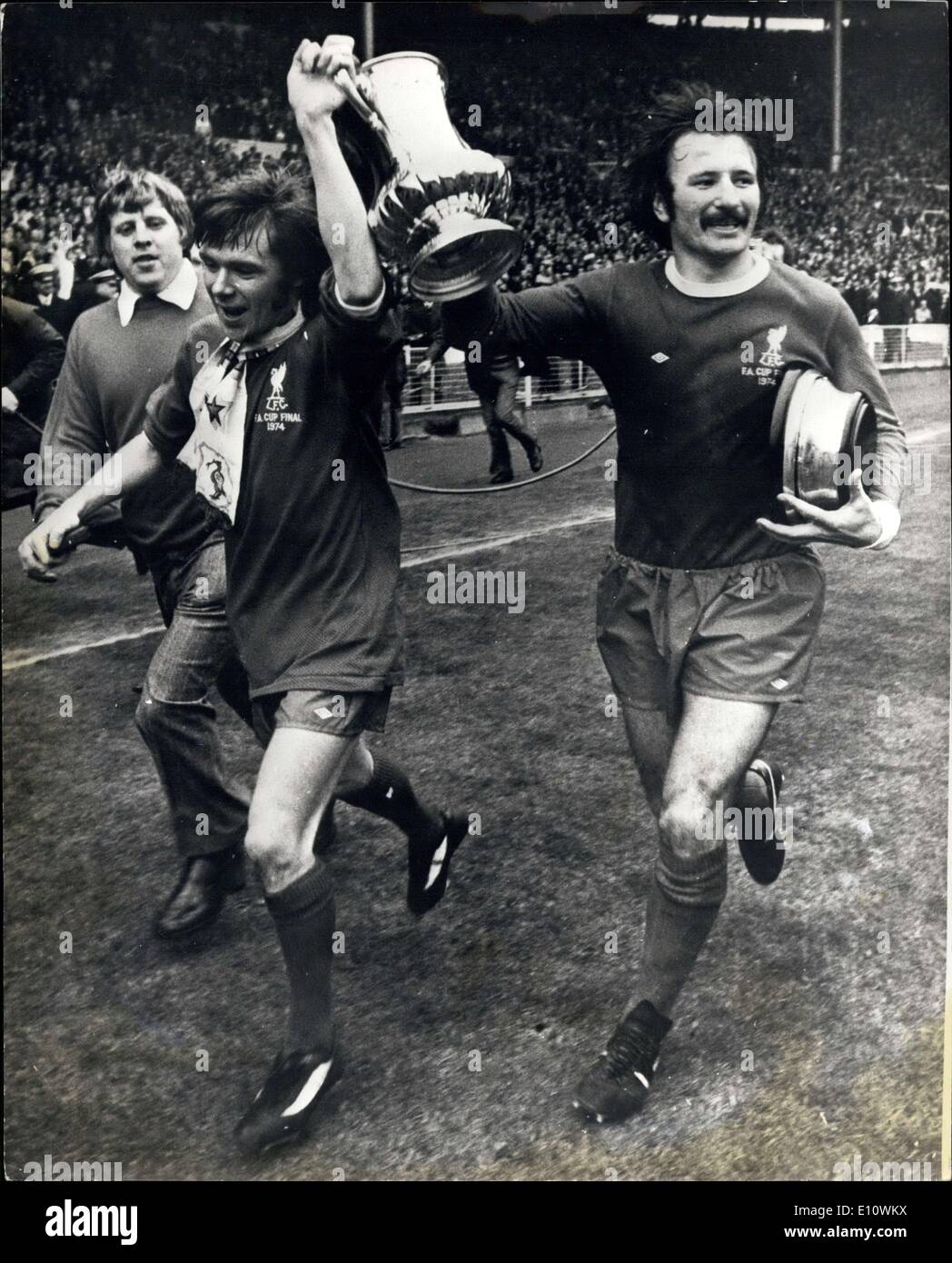 May 04, 1974 - F.A. cup final at Wembley: Liverpool beat Newscastle 3-0. Photo shows Brian Hall (left) and Tommy Smith of Liverpool, hold the F.A. Cup aloft, as they ran round the ground at Wembley today, after beating Newcastle 3-0 in the F.A. Cup Final. Stock Photo