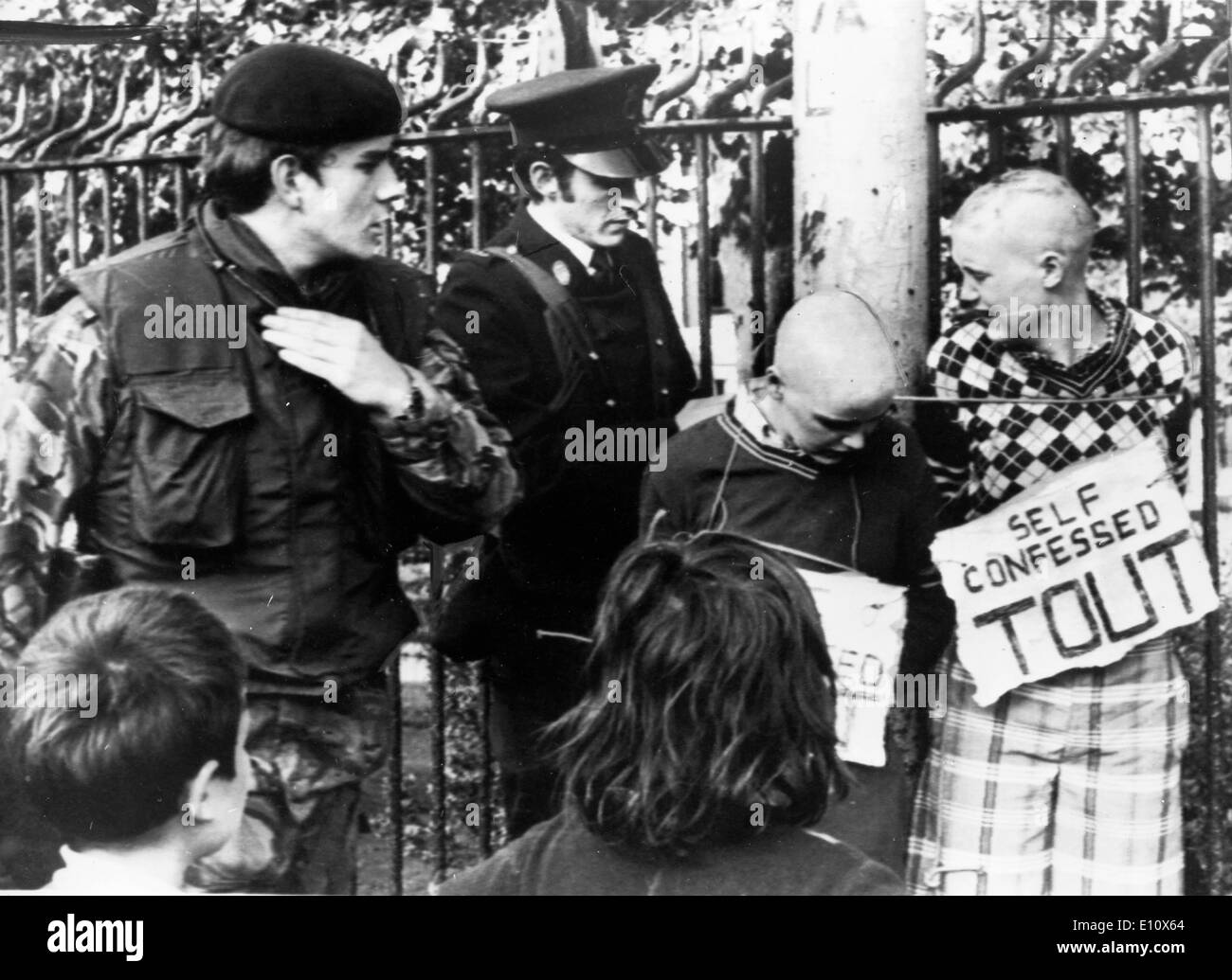 Two young Catholic girls found with their heads shaved and signs that read 'self-confessed touts', Ulster slang for informers Stock Photo