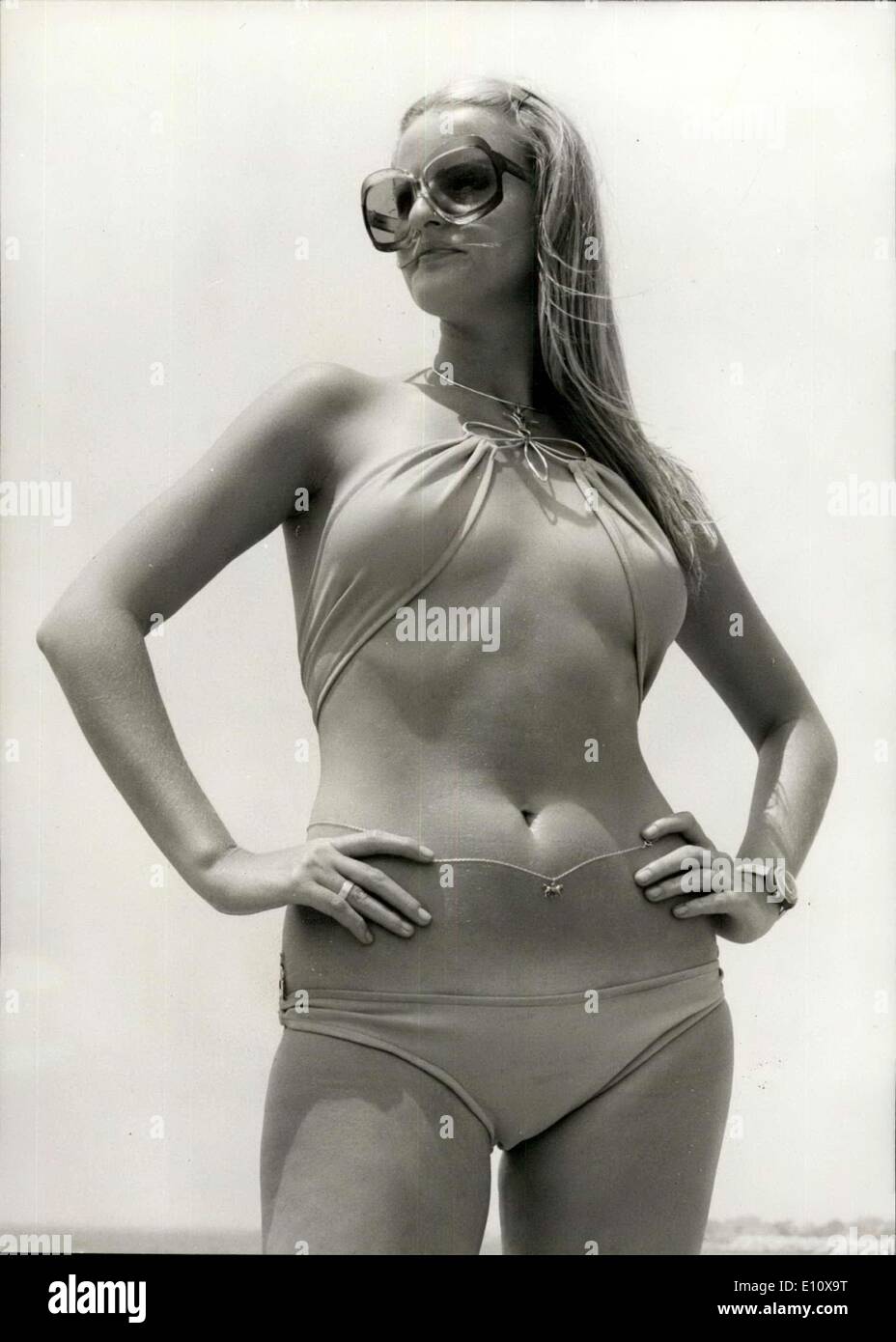 May 07, 1974 - The String is In. The bikini? - well... Strung together with beads, ''shell'' patches, cording and neck loops in Stock Photo