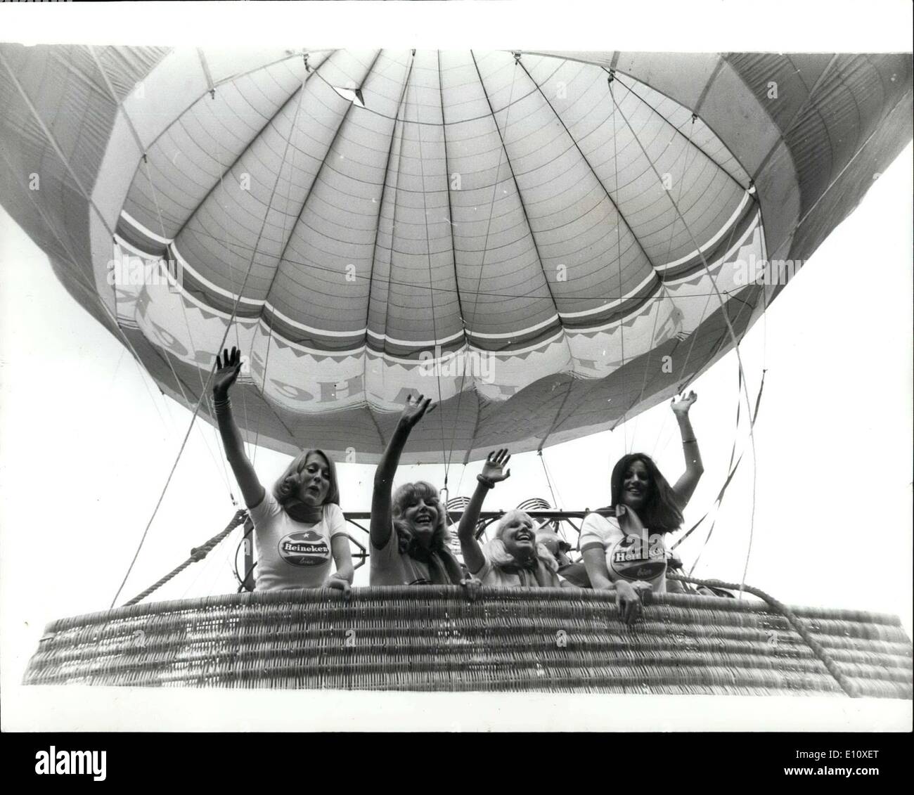 Aug. 06, 1974 - Hot-Beer Balloon: This Heineken Larger's air balloon which is believed to be the biggest in the world, was inflated yesterday at Coram Fields. Bloomsbury, London. It can carry up to 30 people. Photo shows Some the Heineken Girls in the barsket of the balloon after it had been inflated 1 at night. Stock Photo