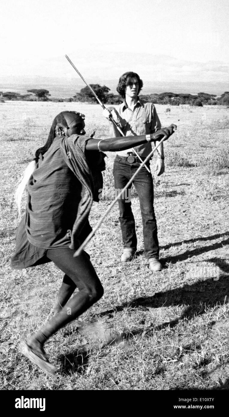 Masai morani (warrior) demonstrates to ROBERT KENNEDY how to throw their special spear Stock Photo