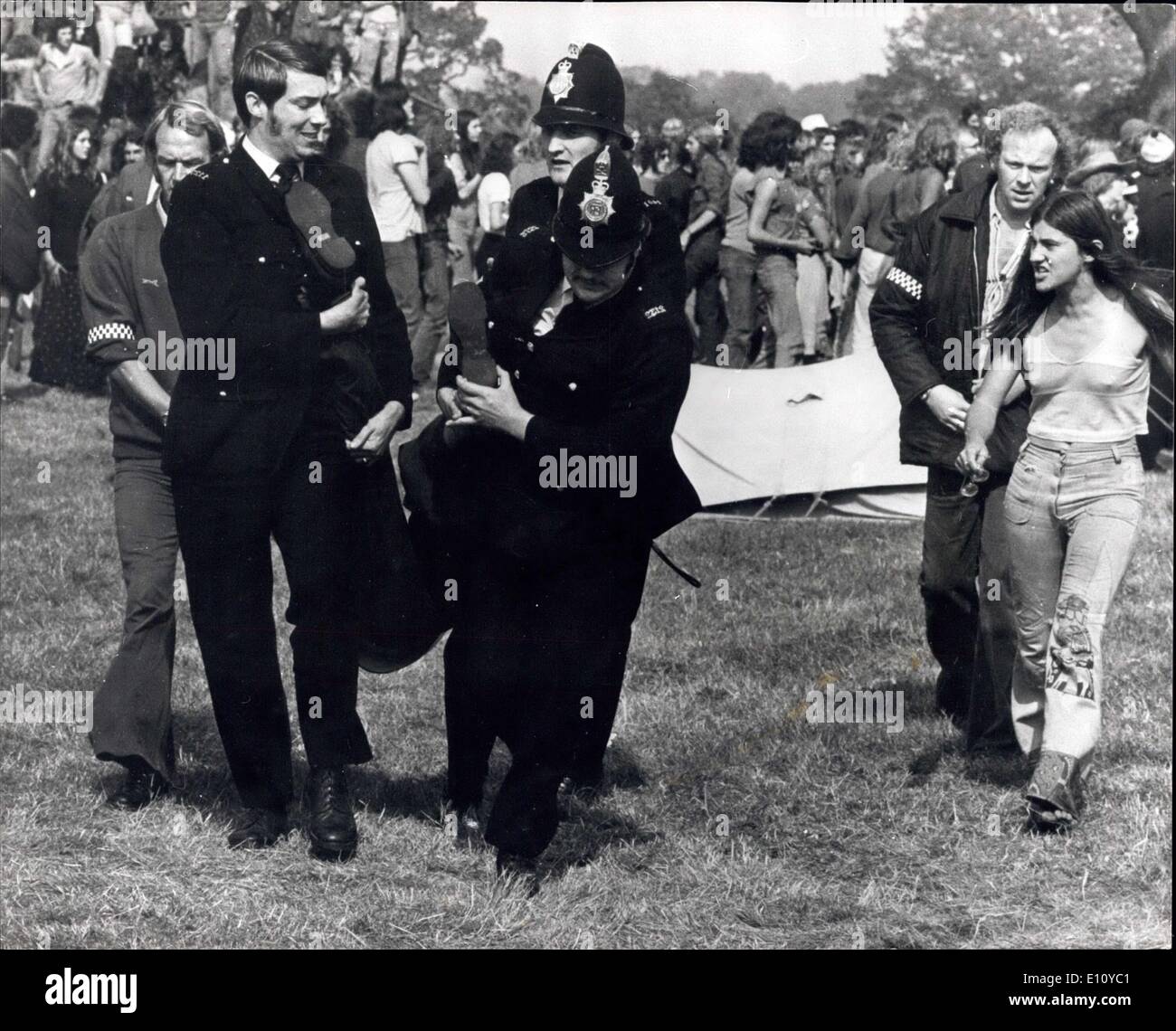 Aug. 30, 1974 - 600 Police Clash With Pop Fans In A ''Clear Out'' Raid At Windsor Great Park: More than 600 police swooped on 2,000 hippies at the Windsor Great Park pop festival and ordered them to ''pack up their tents and go''. Some obeyed the order, but many of them resisted. A scene of hysteria broke out following the clash between the police and the pop fans. Many people were injured, including policemen, and many arrests were made. Photo shows Police removing a pop fan during yesterday's clash in Windsor Great Park. Stock Photo