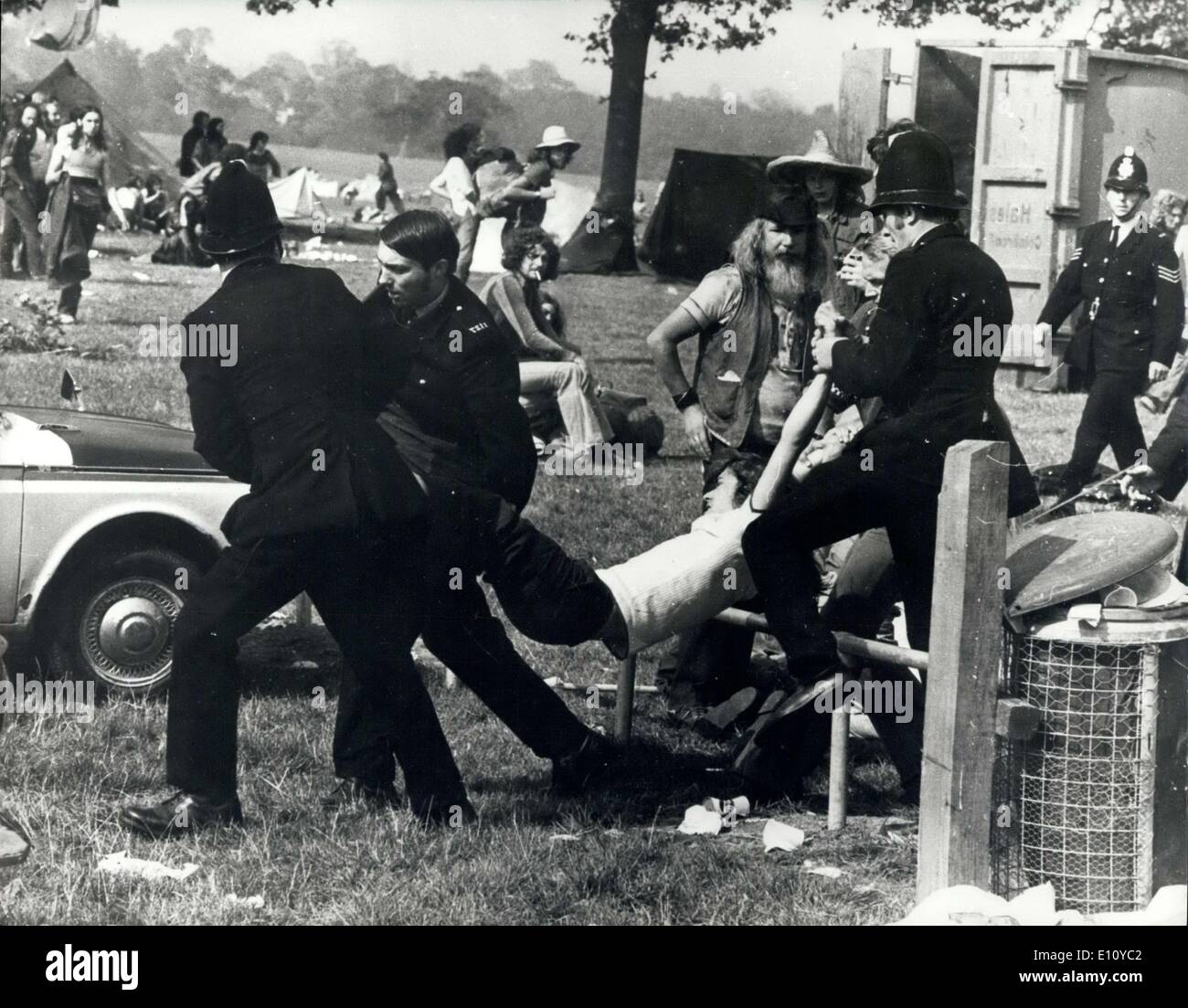 Aug. 30, 1974 - 600 Police Clash with Pop Fans in a ''Clear Out'' Raid at Windsor Great Park.: More than 600 police swooped as 2,000 hippies at Windsor Great Park pop festival and ordered them to ''pack up their tents and go'' Some obeyed the order, but many of them resisted. A scene of hysteria broke out following the clash between the police and the pop fans. Many people were injured, including policeman, and many arrests were made. Photo shows Police seen removing a fan from the scene of yesterday's clash in Windsor Great Park. Stock Photo