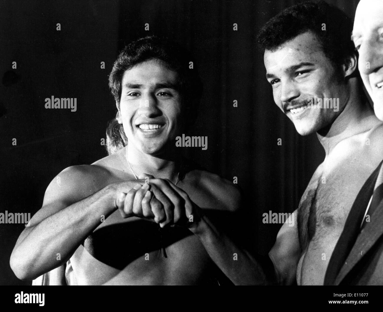 Britain's JOHN CONTEH (R) and JORGE AHUMADA of Argentina, shake hands at weigh in Oct 1, 1974; London, Wembley. Stock Photo