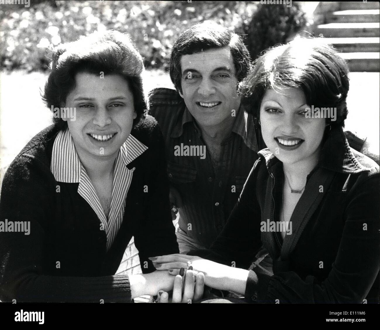 Apr. 04, 1975 - FRANKI VAUGHAN'S DAUGHTER ENGAGED. Singer Frankie Vaughan's daughter Susan, who will be 19 on May 25th, yesterday announced her engagement to 23-year old Paul Sassienie, a sale representative with a City paper merchant. Susan works as a pattern cutter at Christian Dior, in London. Photo shows:- Frankie Vaughan, who is celebrating 25 years in show business, pictured at his Totterridge home yesterday with his daughter Susan and Paul Sassienie(left) Stock Photo