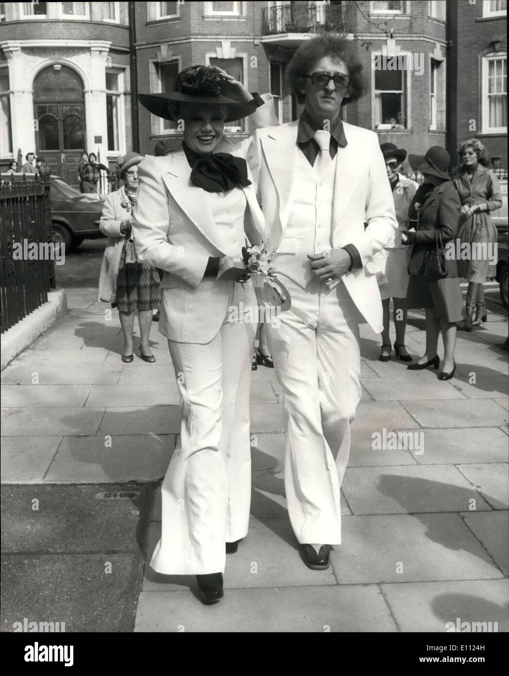 Apr. 21, 1975 - Diana Harvey Weds. Glamorous Diana Harvey, singer and leading lady in the Benny Hill TV series, was married today at Kensington Registry Office, to her musical director, Terry Gittings. Diana is currently appearing in cabaret at the Savoy Hotel, London. Keystone Photo Shows: the happy couple, both in white trousers suits, pictured after the ceremony today. Stock Photo