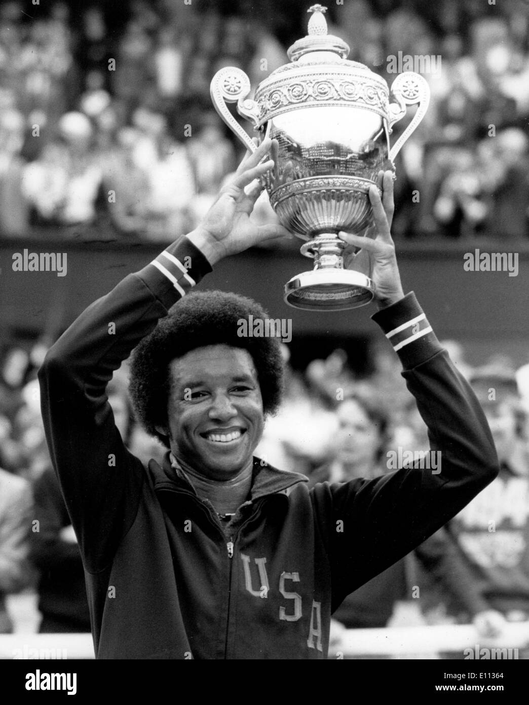 Jul 05, 1975; London, UK; A jubilant ARTHUR ASHE holds his trophy aloft when he became the new men's singles champion by knocking out his fellow countryman, Jimmy Connors (the holder) in the final at Wimbledon today. Stock Photo