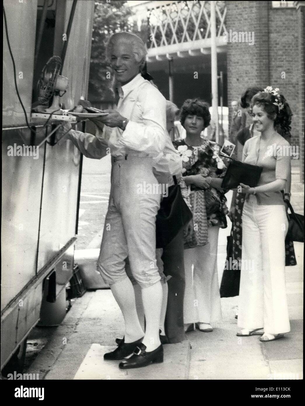 Jul. 07, 1975 - Prince Charming takes his queue for food. Richard Chamberlain who plays the part of Prince Charming in the new &pound;2 million British musical Cinderella is seen here queuing for food during a break in filming. The marriage scene is filmed inside Southwark Cathedral to give the marriage of Prince Charming and Cinderella more realism. Photo Shows: - Richard Chamberlain lines up for food with his co-star Gemma Craven who plays Cinderella standing to his right. Stock Photo