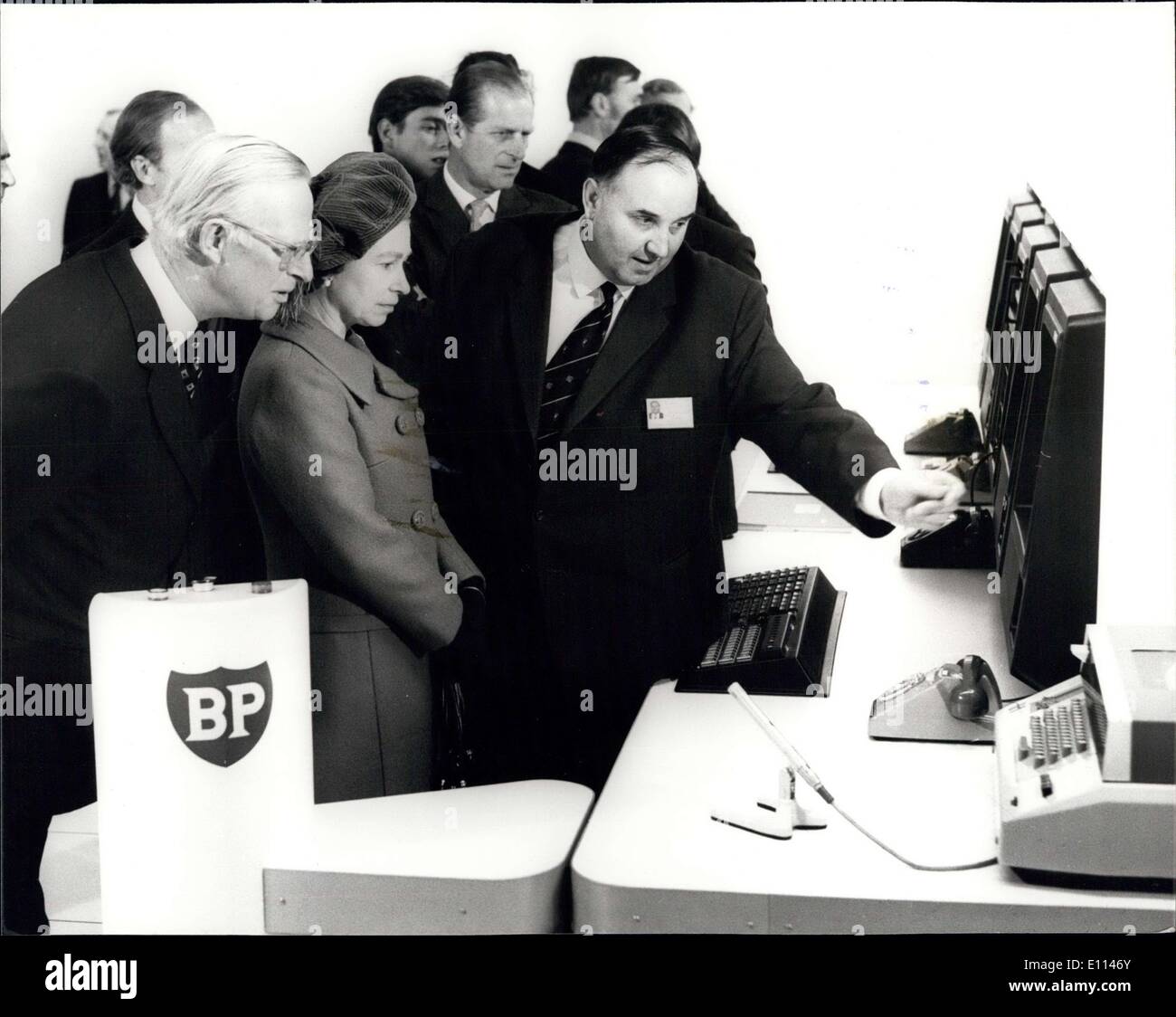 Nov. 03, 1975 - The Queen Presses The Button to Start Britain's Oil Flowing Ashore from The North Sea: Today the Queen symbolically inaugurated Britain's new oil era by pressing a button in a control room at Dyce, near Aberdeen, thus launching the flow of oil from the Forties Field in the North Sea to BP's Grangemouth refinery 237 miles away. Photo shows: Mr. Colin Smith, Senior Production Supervisor, points out a feature of the control system which monitors the oil from the Forties Field to the Grangemouth Refinery, to H.M. The Queen and Sir Eric Drake, Chairman of B.P. Stock Photo