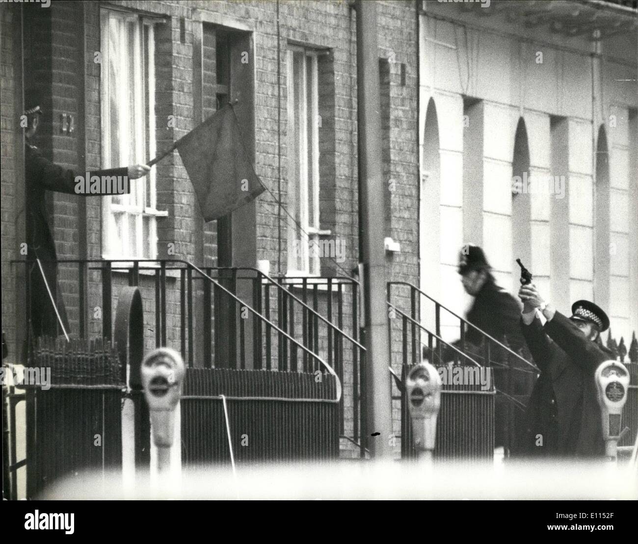 Dec. 10, 1975 - December 10th, 1975 Police use red and green flags as safety precaution at the scene of the London siege - The London siege in which IRA gunmen are holding middle-aged man and his wife hostage in their flat in Balcombe Street, Marylebone, entered into its fifth day today. In the street below police have now adopted a semaphore language by using two flags, one red and the other green which are used for officers entering or leaving the siege building Stock Photo