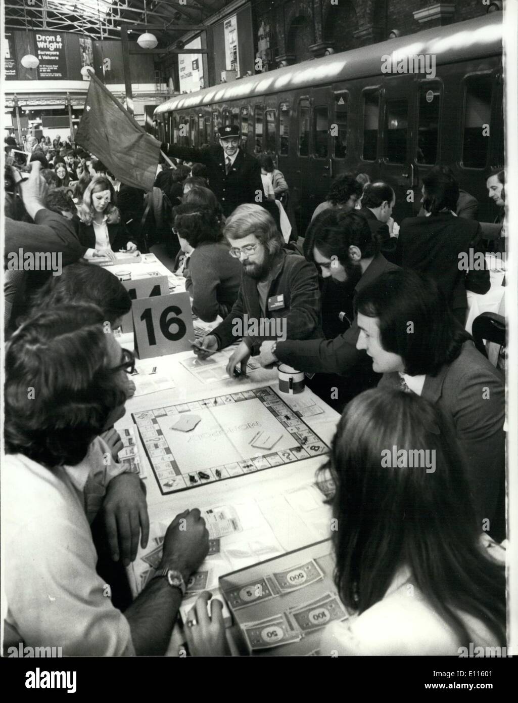 Sep. 09, 1975 - British ''Monopoly'' Championships were today being staged on platforms at Penchurch Street railway station. The British finals are part of a 100,000 international tournament being held to find the World ''Monopoly'' champion. The European Finals take place in Raykjavik in Iceland in November, and the World Final is being held in Atlantic City on November 23rd. Photo Shows A guard waves his flag to get his train away from platform 4 at Penchurch Street Station this morning in spite of over 200 competitors competing in the ''Monopoly'' championship taking place there. Stock Photo