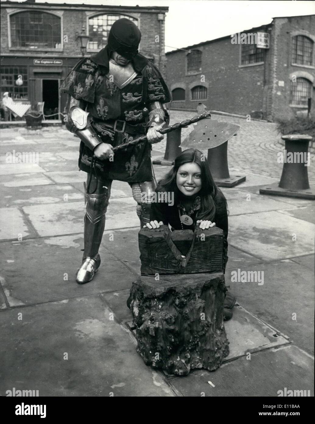 Nov. 11, 1976 - Miss World's Take A Trip On The Thames Contestants for the ''Miss World'' contest which takes place at the Royal Albert Hall, took a trip on the River Thames, aboard the :Father Thames'' pleasure boat. Photo Shows:- Miss Australia, 19 year old Karen Jo Pini with her head on the chopping block during a visit to the Tower of London - during a break in their river trip-the man holding the axe is Mr. Tim Condren who is a professional Knight and stunt man. Stock Photo