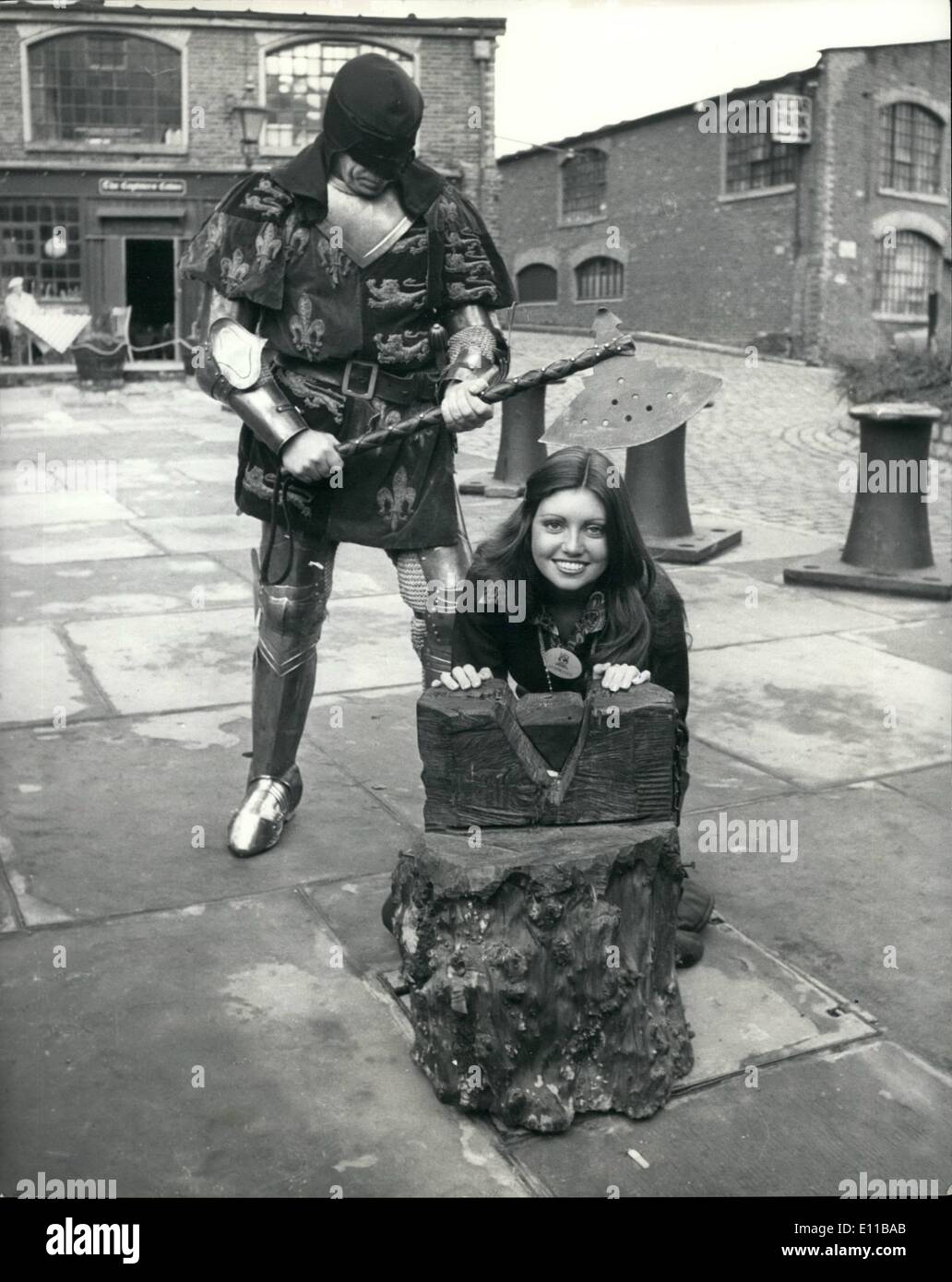 Nov. 11, 1976 - Miss World's Take A Trip On The Thames. Contestants for the ''Miss World'' contest which takes place at the Royal Albert Hall, took a trip on the River Thames, aboard the ''Father Thames'' pleasure boat. Photo Shows:- Miss Australia, 19 year old Karen Jo Pini with her head on the chopping block during a visit to the Tower of London - during a break in their river-trip-the man holding the axe is Mr. Tim Condren who is a professional Knight and stunt man. Stock Photo