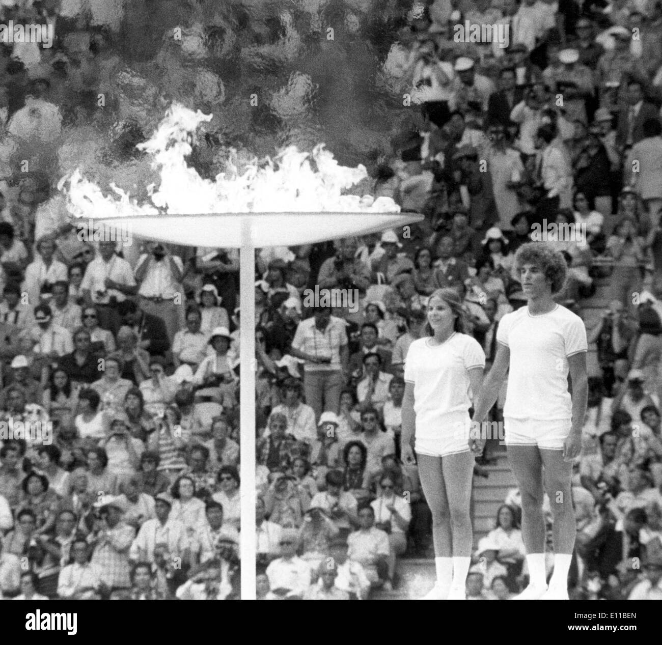Jul 20, 1976; Montreal, Canada; Two young Canadian athletes stand before the Olympic flame after