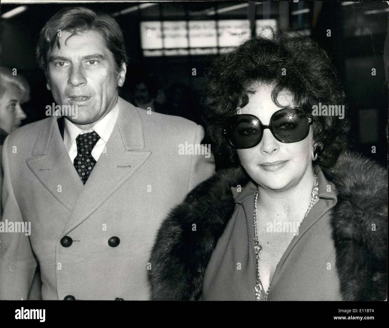 Dec. 12, 1976 - Elizabeth Taylor Arrives With Husband Number Seven: Elizabeth Taylor flew into Heathrow Airport today with her seventh husband, 49-year-old John Warner a former U.S. Secretary for the Navy. The couple were married recently at the politician's estate in the Blue Ridge Mountains, near Middlesburg, Virginia. Liz, 44, and her husband are staying at the Dorchester Hotel in London. Richard Burton, who was married to Liz for the ten years, has also booked into the same hotel with his new wife Suzy Hunt, the former wife of James Hunt, the world champion motor racing driver Stock Photo