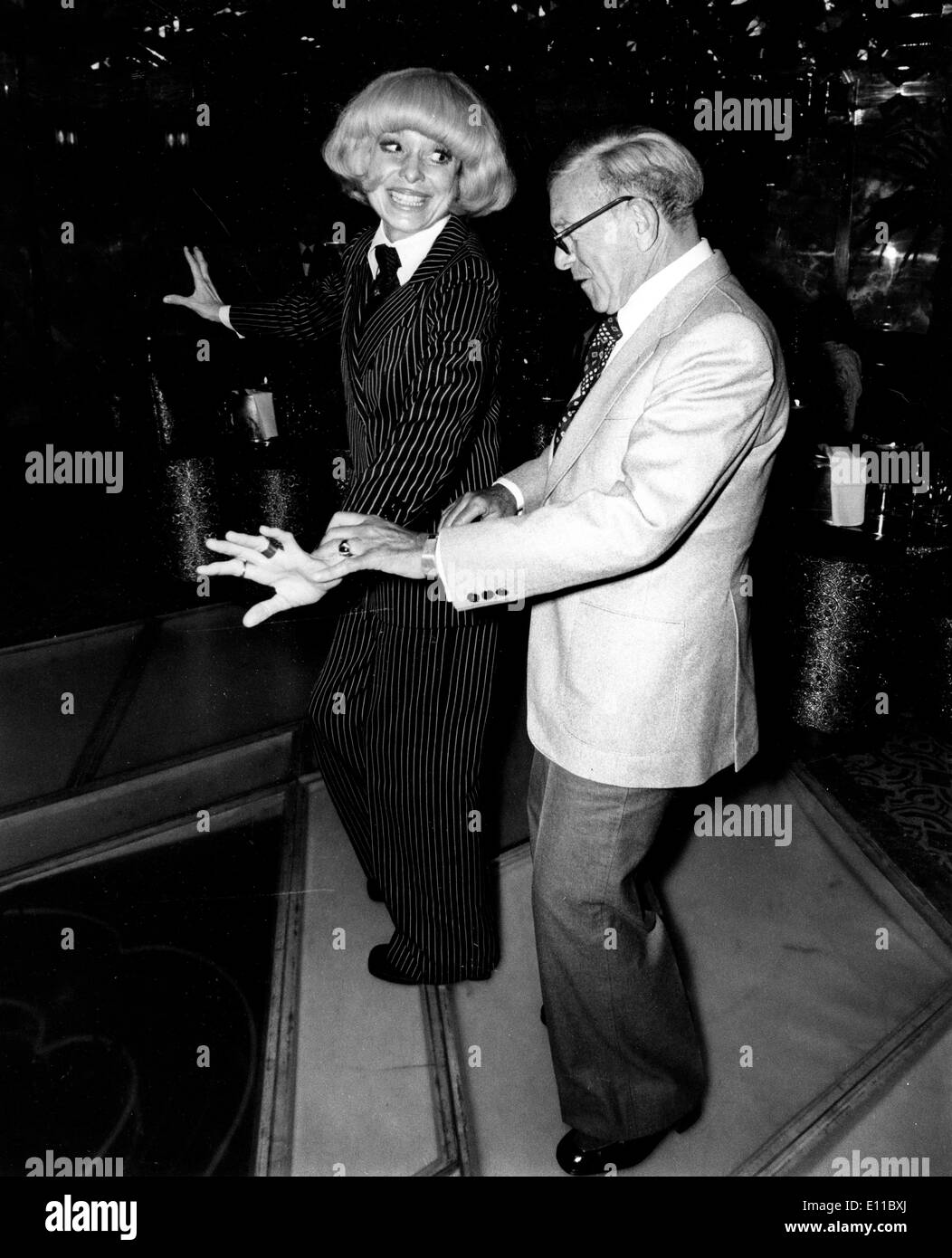 Aug 16, 1976 - New York, New York, U.S. - CAROL CHANNING with GEORGE BURNS at Regine's disco in New York's Delmonico Hotel. They will open their two-person revue on Tuesday at the Westbury Music Fair in Westbury, New York. . Carol ElaineCchanning (born January 31, 1921, Seattle, Washington) is an American singer and actress. The recipient of three Tony Awards (including one for lifetime achievement), a Golden Globe and an Oscar nomination, Channing is best remembered for her role Lorelei Lee in Gentlemen Prefer Blondes, and as Dolly Gallagher Levi in Hello, Dolly! Stock Photo