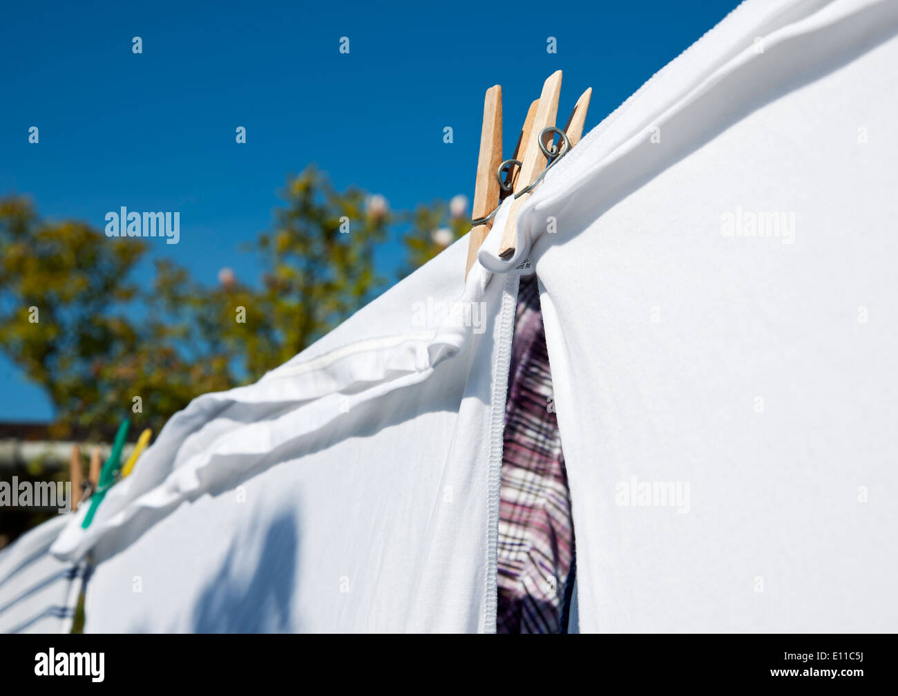 Close up of clean clothes laundry drying hanging outside on a washing line wash day England UK United Kingdom GB Great Britain Stock Photo