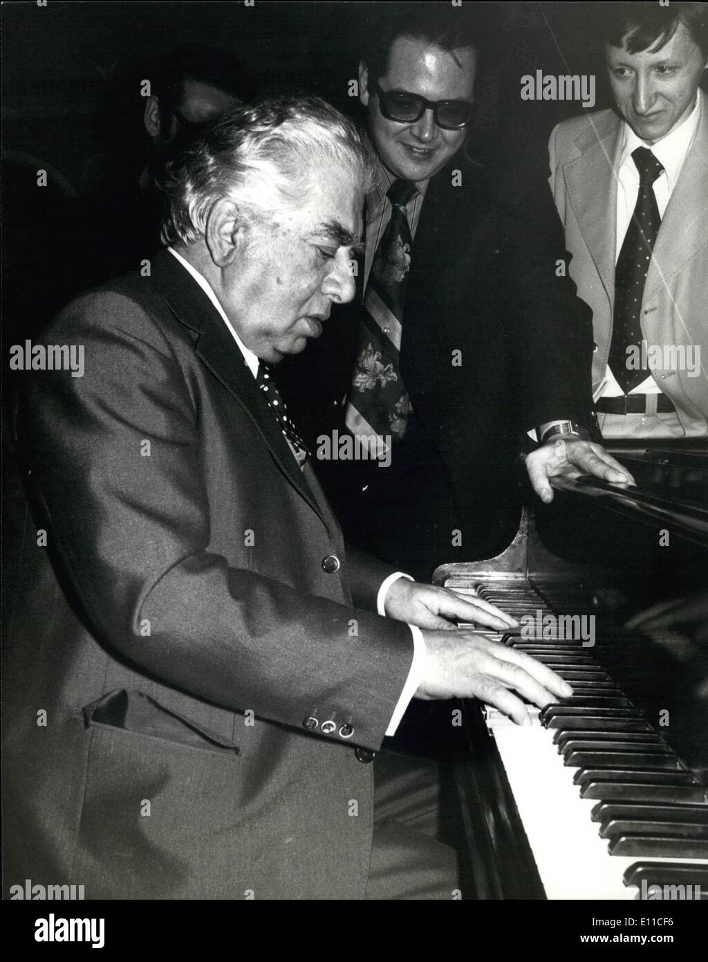 Jan. 01, 1977 - Russian Composer Aram Khachaturian in London For Two Concerts: The Russian Composer 73 year-old Aram Khachaturian is in London to conduct two concerts with the London Symphony Orchestra at the Royal Festival Hall. Photo shows Aram Khachaturian seated at the keyboard during a reception at the Dorchester today. The man standing next to him will play the piano in the two concerts given by him. He is Nicolai Petrov. Stock Photo