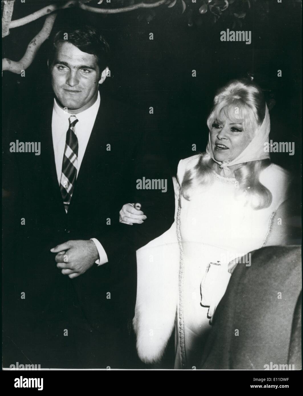 Sep. 09, 1977 - Mae West - Still Makes The Hollywood Scene: Mae West, whose hourglass figure made her the sexpot of films in the 1930's still makes the Hollywood scene despite her 76 years. Here she is seen with former professional football player, Adrian Strange. Mae seems to continue her leaning, towards young muscular men as she did in her ''Diamond Lil' days. Stock Photo