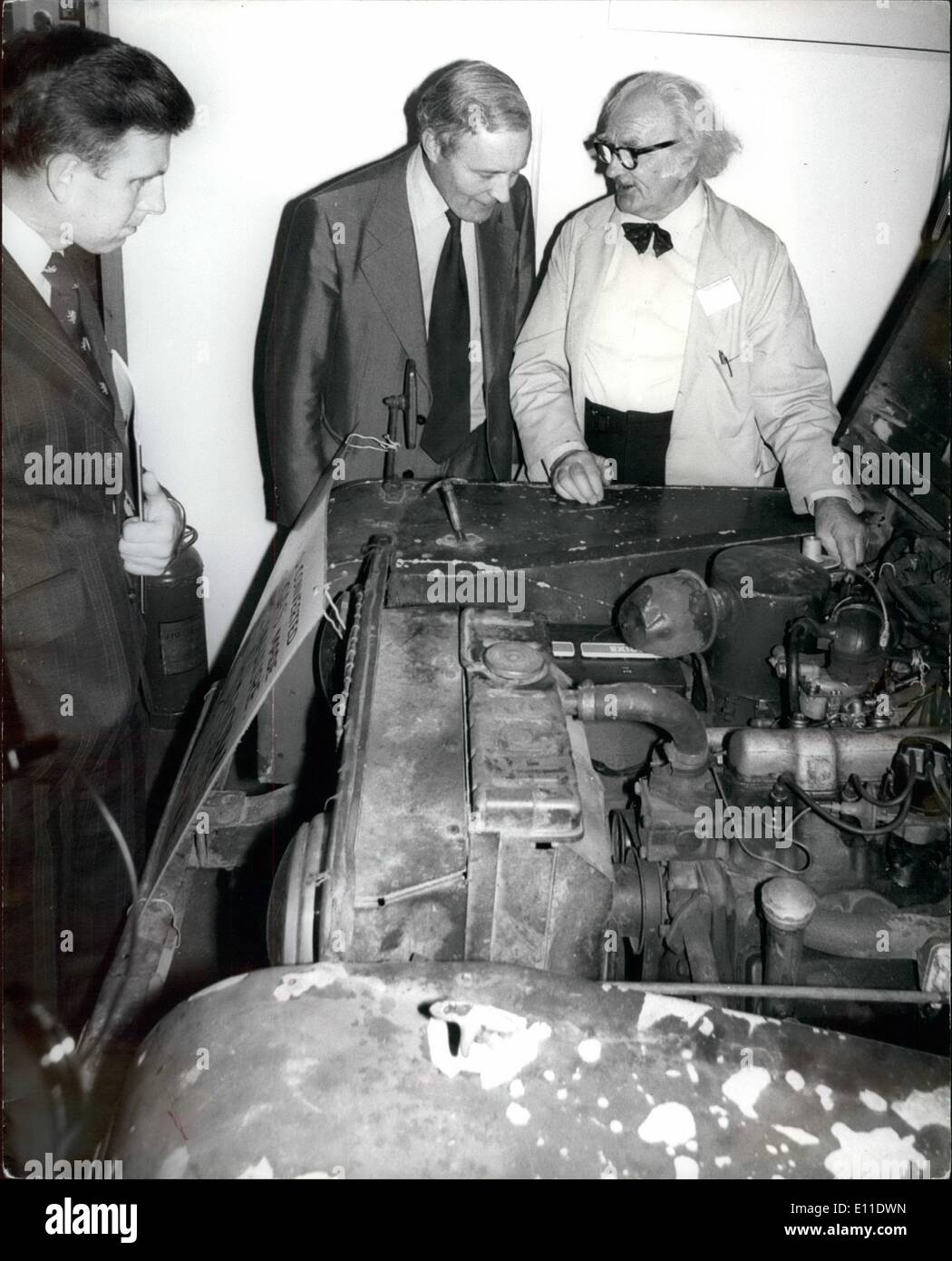 Sep. 09, 1977 - Energy minister Wedgwood Benn opens energy Exhibitions at Olympia : Photo shows Inventor Harold Bate explains to Mr. Benn his method of running a car at twentieth of the usual cost. His fuel is literal chicken food, by using highly toxic chicken manure to produce methane gas. Stock Photo