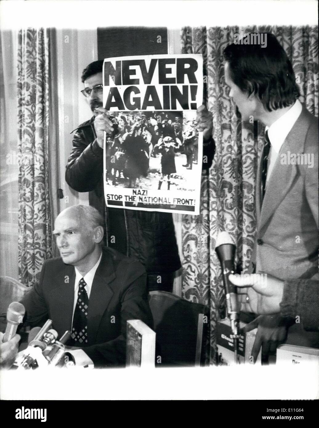 Nov. 11, 1977 - Anger as SS Chief Freed: Former SS Colonel Hubert Meyer, banned from Britain by the Home Secretary Mr Merlyn Rees, was given nearly a days grace today. Police at Heathrow Airport released him and he was driven to a London Press Conference by his book Publisher. The Home office have made it clear that Col. Meyer must be out of the country by midnight tonight. Meyers book is about the SS during the War. Picture Shows: Colonel Hubert Mayer talking at the Press Conference today with a demonstrator standing behind him and Meyer's publisher Patrick Henchy Standing next to him. Stock Photo
