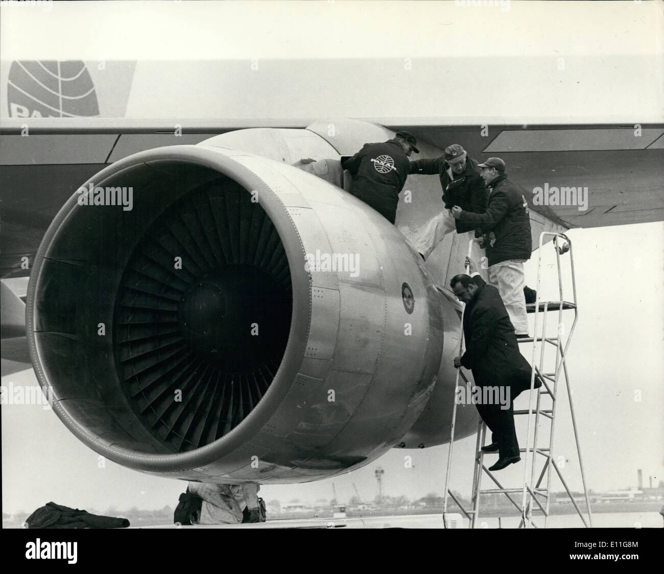 Jan. 01, 1978 - Jumbo jet arrives at heath-row Pan American's 350 ton Boeing 747 jumbo jet the world's biggest airliner made its first flight to heath-row airport yesterday. photo shows Technicians examining one of the Jumbo jet's Pratt and Whitney engines, which failed to start on its first demonstration flight from heath-row. It took more than two hours to get the engine running. Stock Photo