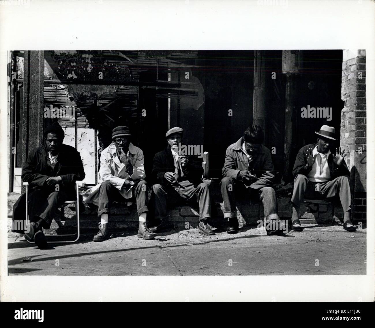 Apr. 18, 1978 - South Bronx, New York: Jobless were sitting in a burned-out store window enjoying the sunshine. The few parks in the area are generally unsafe. Stock Photo