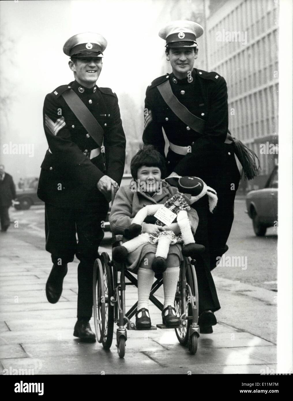 Feb. 02, 1979 - 8 year-old Karen Whiteside a Cancer Suffer is the Special Guest of the Royal Marines.: 8 years-old Karen Whiteside, from Fulwood, near Preston, arrived at London's Euston Station today and was greeted by two members of the Royal Marines. Band. She is the special guest of the Marines at the Malcolm Sargent Cancer Fund for Children which takes place at the Royal Albert Hall tomorrow night, in which they will be playing. Photo shows The two members of the Royal Marine Band, Sgt Duck MacArdls , left , and Sgt. Tom Simpson give Karen a push after meeting her at Euston Station today Stock Photo