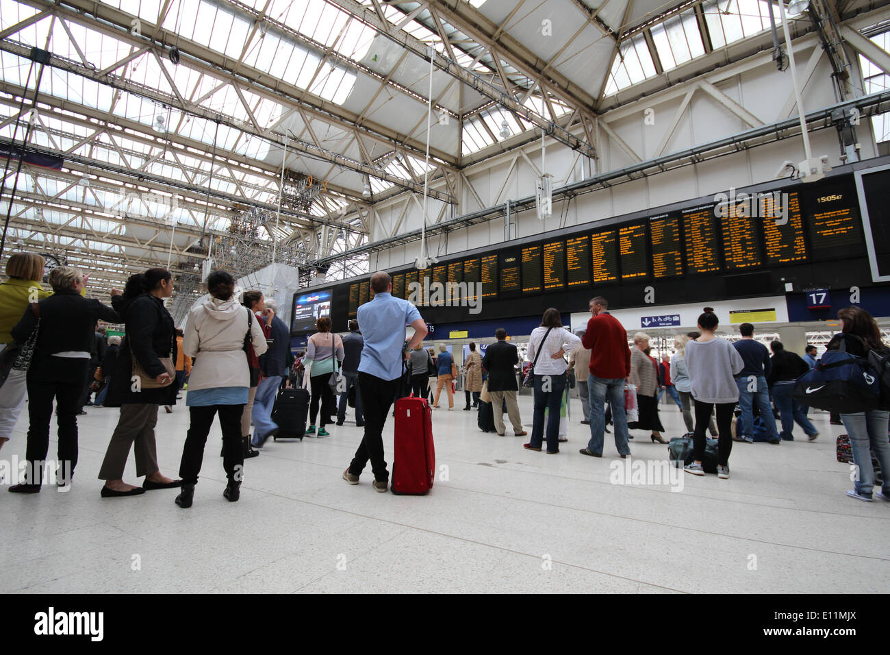 Passengers looking at the departure board at Waterloo station Stock ...