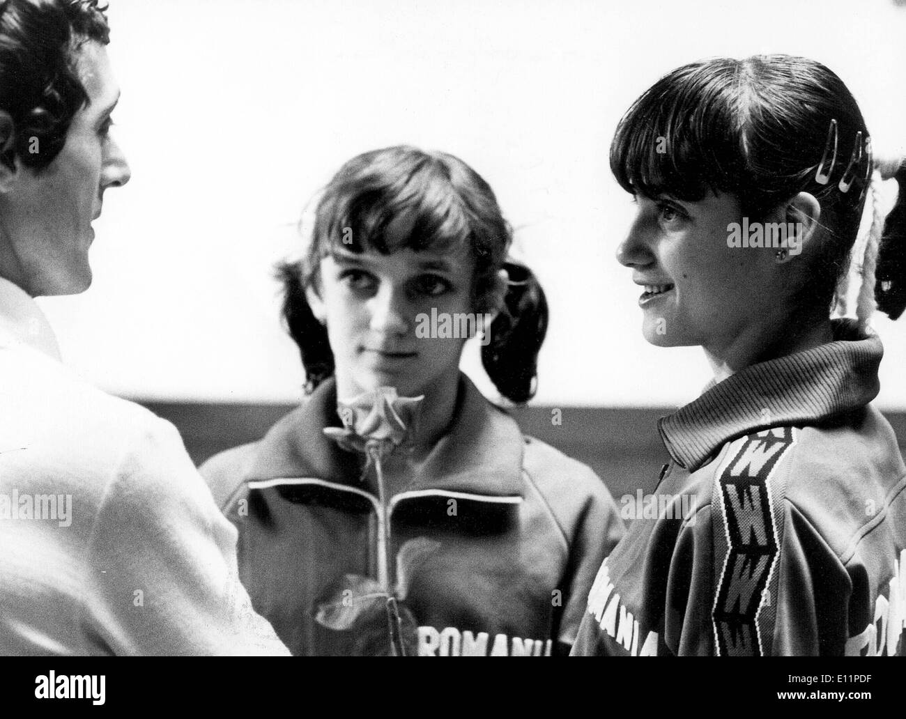 Jun 05, 1979; Tokyo, Japan; Gymnast NADIA COMANECI relaxes over a chat with the Romanian manager after she finished all the performances. She is seen with fellow Team-mate (center), EMILIA EBERLE, who ranked second in the overall result.. (Credit Image: KEYSTONE Pictures USA/ZUMAPRESS.com) Stock Photo