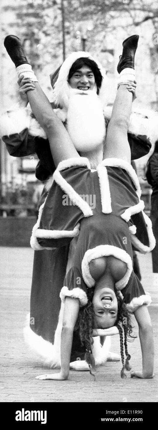 Dec 17, 1979; London, UK; 18 year-old SIS PEDERSEN, from Denmark, displayed just a little more of her charms than she wanted when she did a handstand in her Santa gear yesterday. Sis was limbering for the world disco dancing championships which takes place in London tomorrow. Holding her ankles is last year's winner, TADAAKI 'Teddy' DAN, 22 years old. (Credit Image: KEYSTONE Pictures USA/ZUMAPRESS.com) Stock Photo