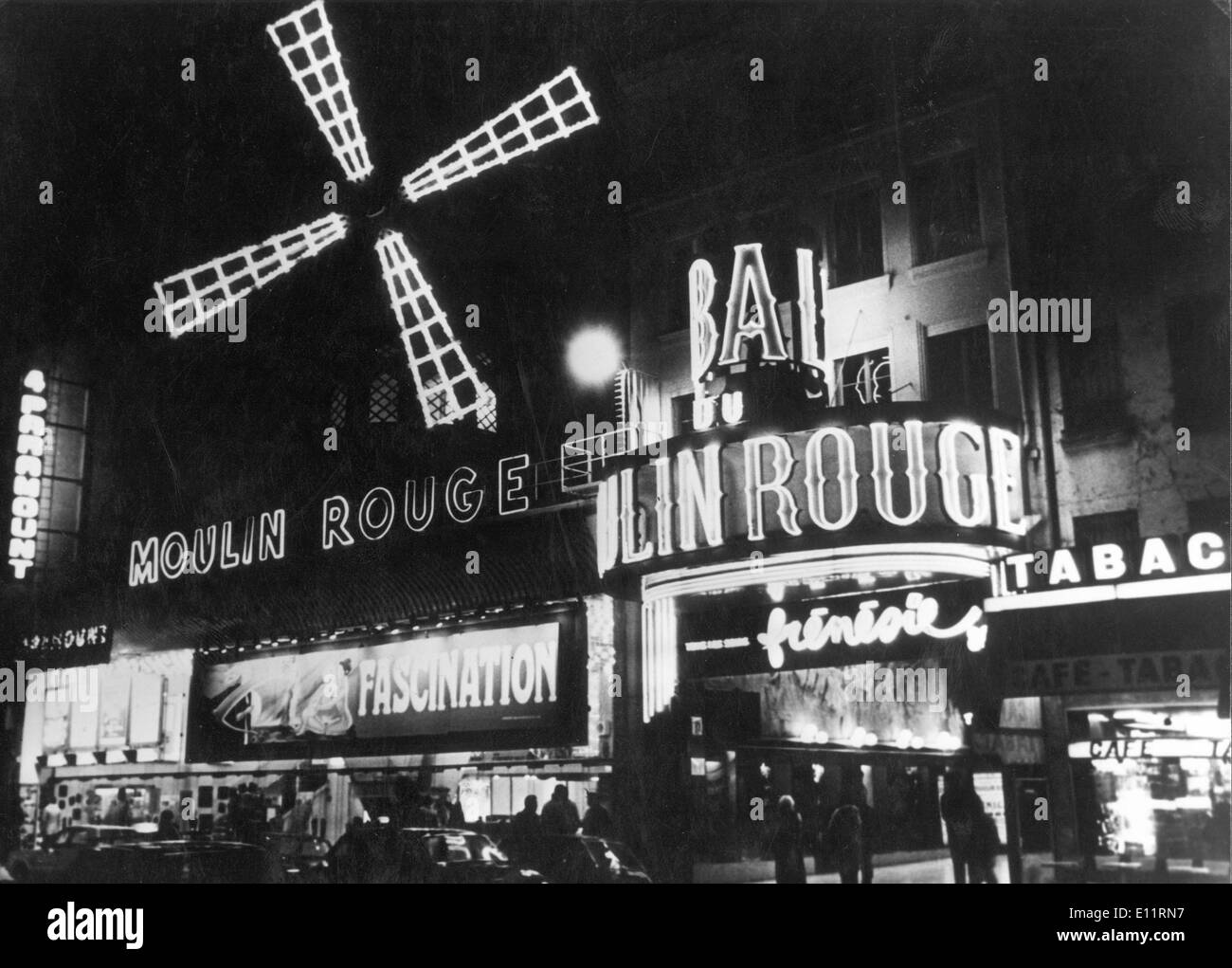 Jan. 1, 1980 - Paris, France - World-famous Moulin Rouge Cabaret, immortalised by Toulouse-Lautrec is located in Montmartre, the only place in Paris where you can see the real Can Can. The Moulin Rouge is a tourist destination, offering musical dance entertainment for adult visitors from around the world. Much of the romance from turn-of-the-century France is still present in the club's decor. Many international stars have performed on stage at the Moulin Rouge: Ella Fitzgerald, Liza Minelli, Frank Sinatra, Elton John Stock Photo