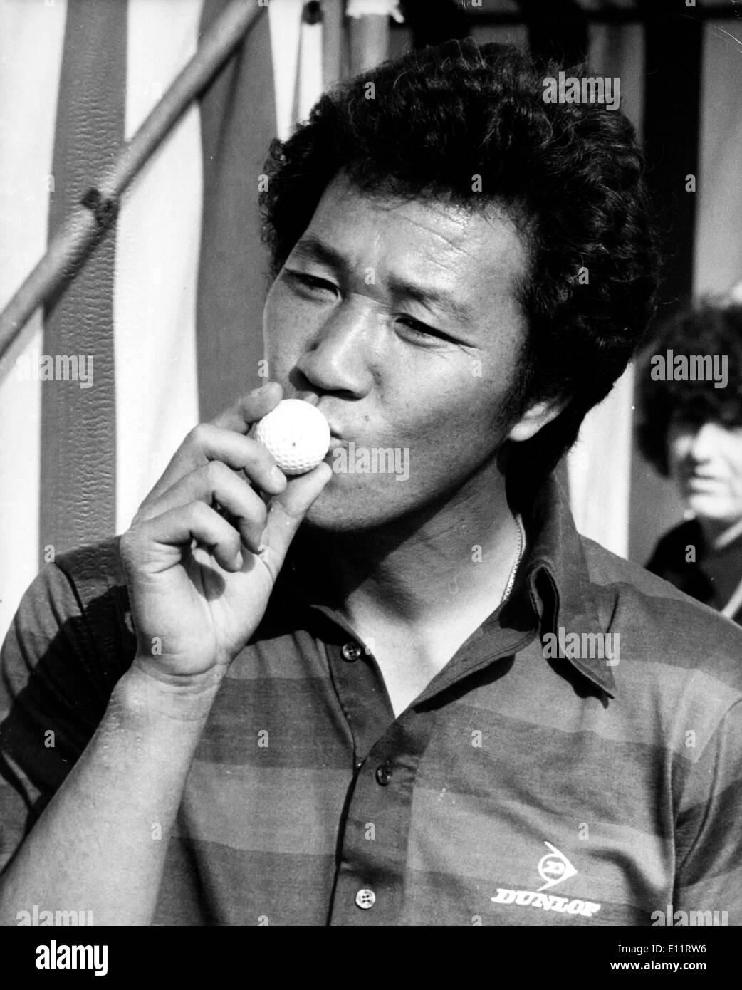 Oct 12, 1979; Wentworth, Scotland; The Japanese Golf star ISAO AOKI made a hole in one at the 155 yard second hole during the Suntory World Matchplay Championships at wentworth today. It won him a 40,000 pounds house overlooking the famous Gleneagles golf course in Scotland, and 15,000 pounds with which to furnish it. This is the biggest golf prize eveer won in Britain. The picture shows Aoki giving the ball a kiss after he had holed the second in one at Wentworth today. Stock Photo