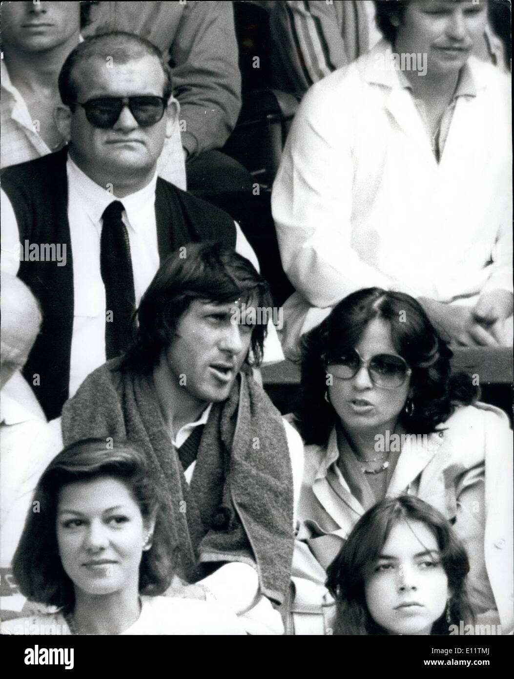 Jul. 07, 1980 - Ilie Nastass the Romanian tennis star, and is parted from his wife Dominique, who is seeking a divores is seen with's girl friend as the watch the tennis on the centre at Wimbledon, Seated behind them is the massive from of Nastase bodyguard Bambind. Stock Photo