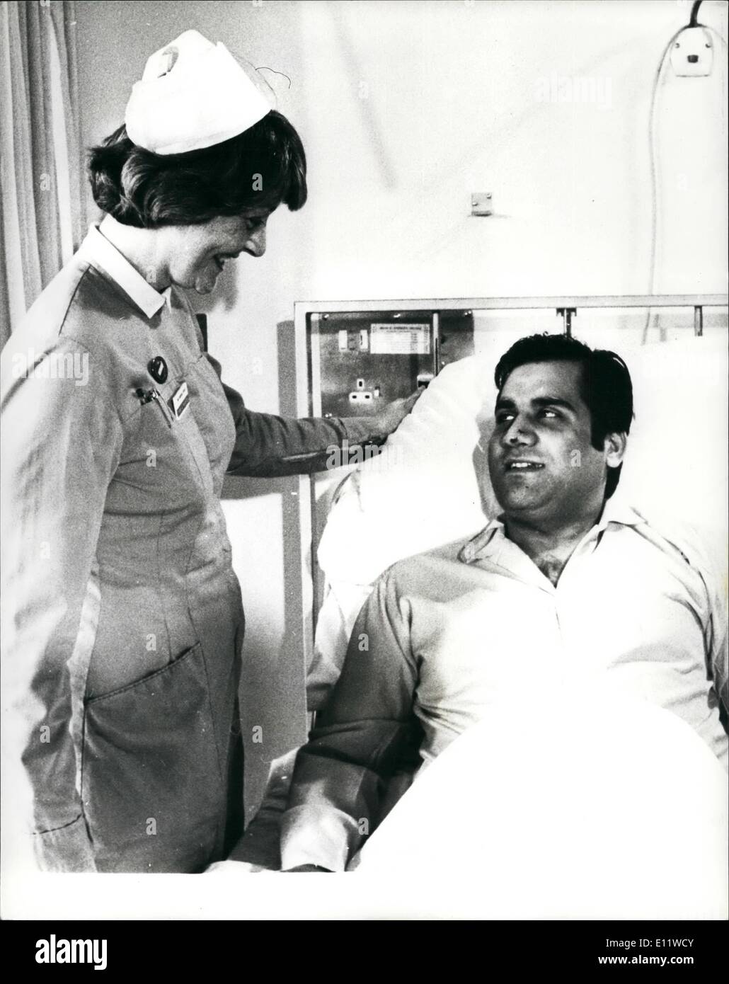 May 05, 1980 - First Picture of Wounded Iranian Charge affairs: The Iranian Charge de Affairs Dr. Gholam-Ali Afrouz who was shot by terrorists on the last day of the six-day siege of the Iranian Embassy in London, which ended when the SAS stormed it on Monday night. Is seen sitting up in bed today at St. Stephens Hospital talking to Sister Jaqueline Peirce. Stock Photo
