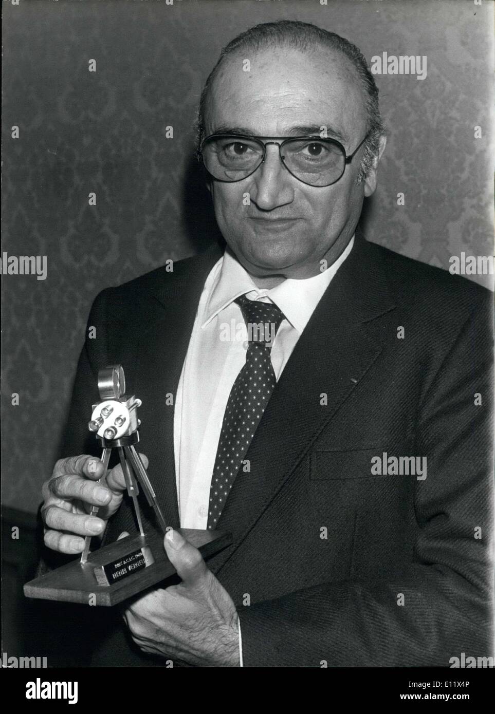 Jun. 25, 1980 - French director Henri Verneuil received the ''Prix ACIC 1980'' during a reception in Paris. He is pictured presenting his prize, a mini-golden camera. Stock Photo
