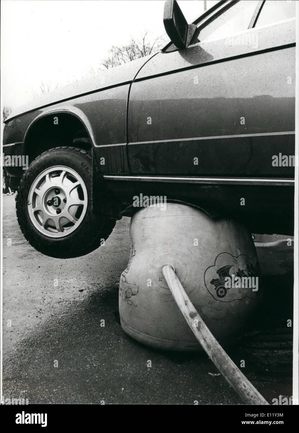 Mar. 03, 1981 - In the future; it will be very easy to ''lift'' a car because of this newness, being introduced at the international fair craft, taking place at present in Munich. ''Air Jack'', the modern lifting jack of the eighties, finds a place in a small, handy case. If it is needed-possibly to to change tyres, to use snow chains or to get a car going again, if the tyres have been sinked into the slough this apparatus will be put under the car and it will be fastened with lock at the exhaust by a flexible pipe of four meters. Then it will be blown up, and so the car can be lifted Stock Photo