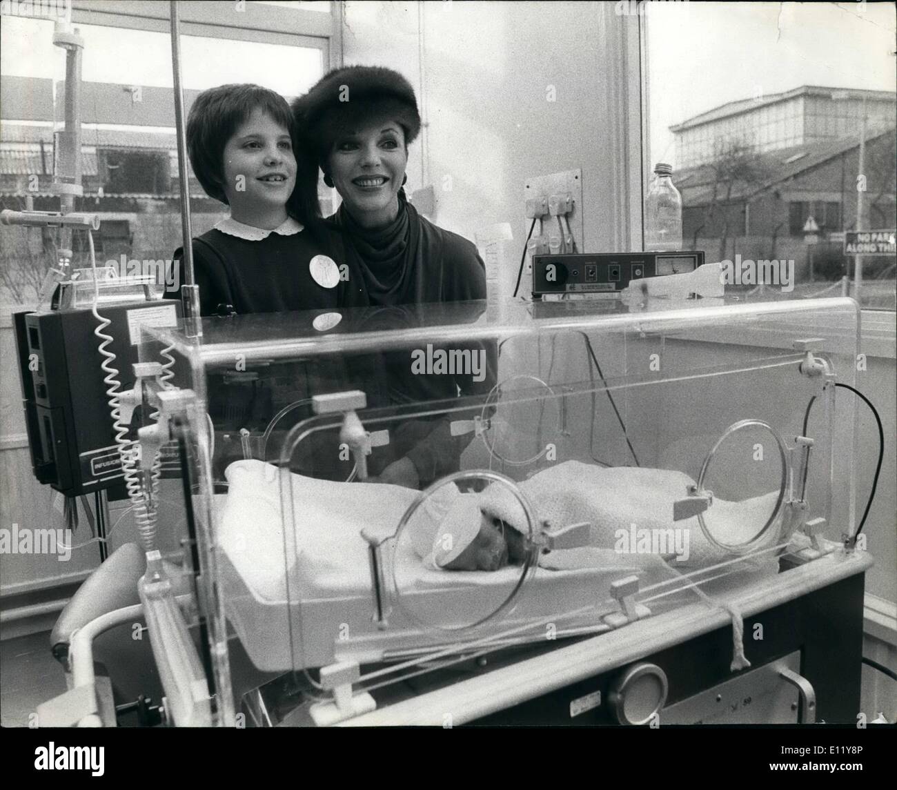 Dec. 12, 1980 - Joan Collin's smile says thank you: The gratitude showed on actress Joan Collin's face when she went back with her daughter Katyana to the hospital where doctors saved her young life after a road accident. Back in the summer 8 year old Katy spent 42 days in a coma at the Central Middlesex Hospital in London. On Friday the 46 year old star went back to the hospital to present the hospital with &pound;3,000 worth of baby care equipment, including an inducator. The money for the equipment was collected by the Charity Bliss Stock Photo