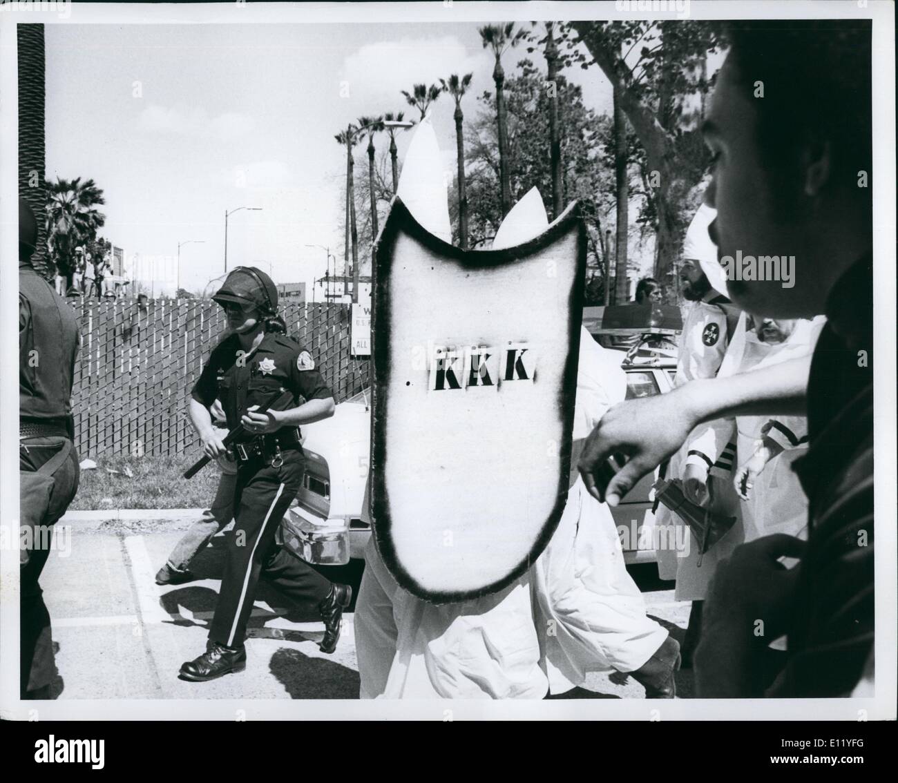 Apr. 04, 1981 - Klansmen Shield themselves from the angry, rock-throwing crowd, who forced the Klan to cancel the scheduled recruitment rally in San Jose, California. Stock Photo