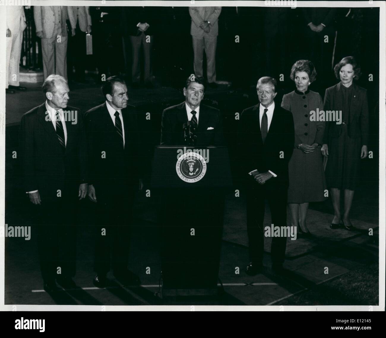 Oct 08, 1981 - Washington, District of Columbia, U.S. - President Ronald W.Reagan (at podium) as he addressed the nation to eulogize the late president Anwar Sadat of Egypt. Sadat was assassinated October 6th in Cairo while reviewing a parade. shown left to right in this historic picture are: Former president Gerald R. Ford; Former president Richard M. Nixon; (president Reagan); And former president Jimmy Carter. At right are Mrs.Jimmy Carter and Mrs.Ronald Reagan. The four men will be part of the U.S. Delegation attending the funeral for the slain leader. Stock Photo