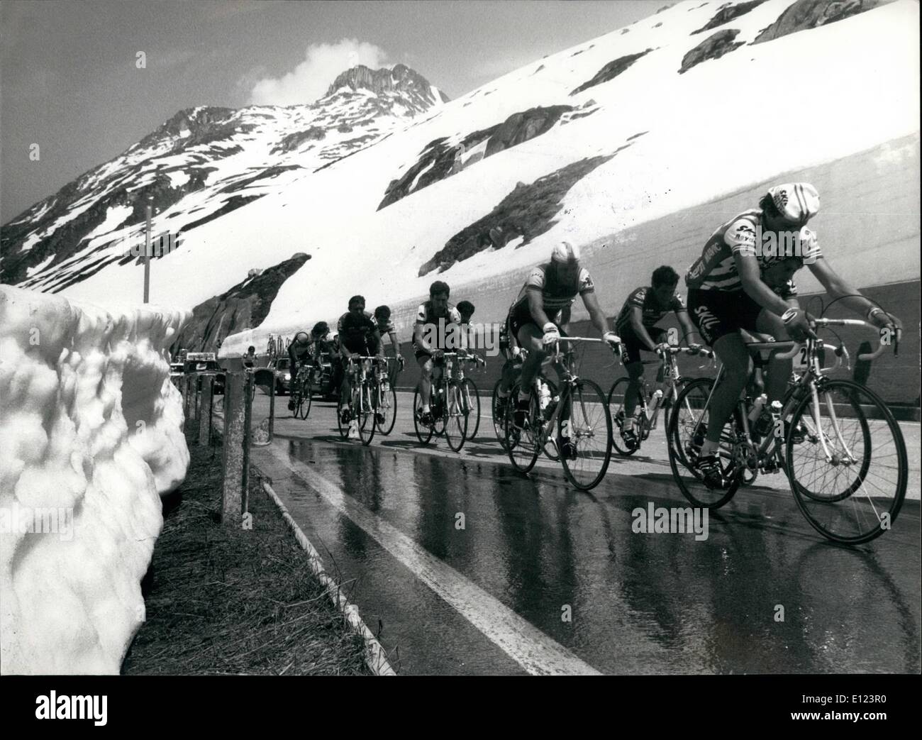 Jun. 06, 1984 - Snow walls on the Saint Gotthard Pass: Cyclists of the ''Tour de Suisse'' pass through big snow walls on both sides of the street on the Saint Gotthard pass (Swiss alps) during the 5th lap of this cycling race Monday. Stock Photo