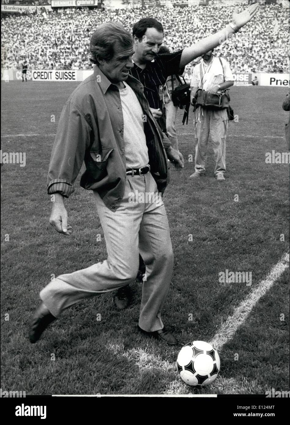 May 05, 1986 - Start-Kick by Belmondo: The French actor Jean-Paul Belmondo kicks the ball for the start of the Swiss Cupfinal, the decision-play between Sion (Canton Valais) and Geneva. Sion won the party in Berne 19-5-86 with 3:1. Stock Photo