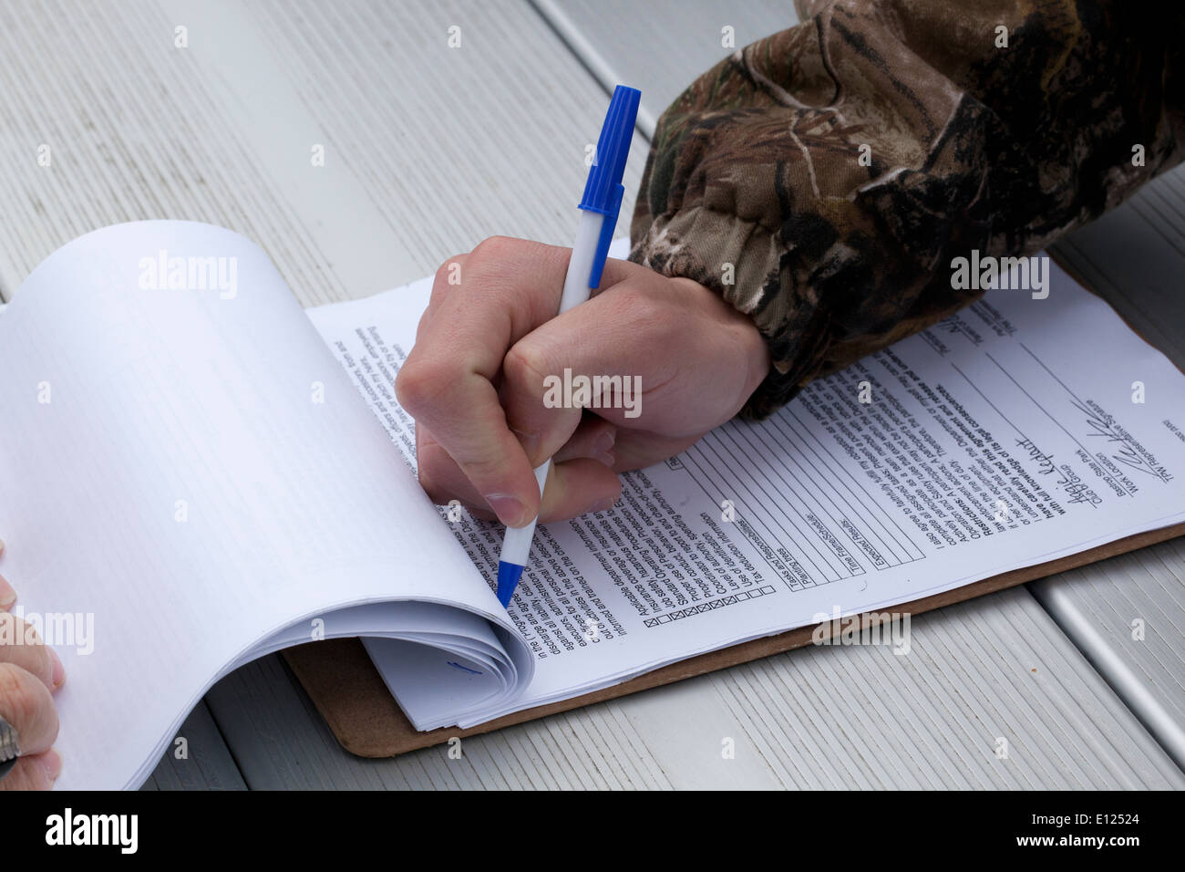 Texas A&M University student signs a release prior to participating in pine tree replanting effort. Stock Photo
