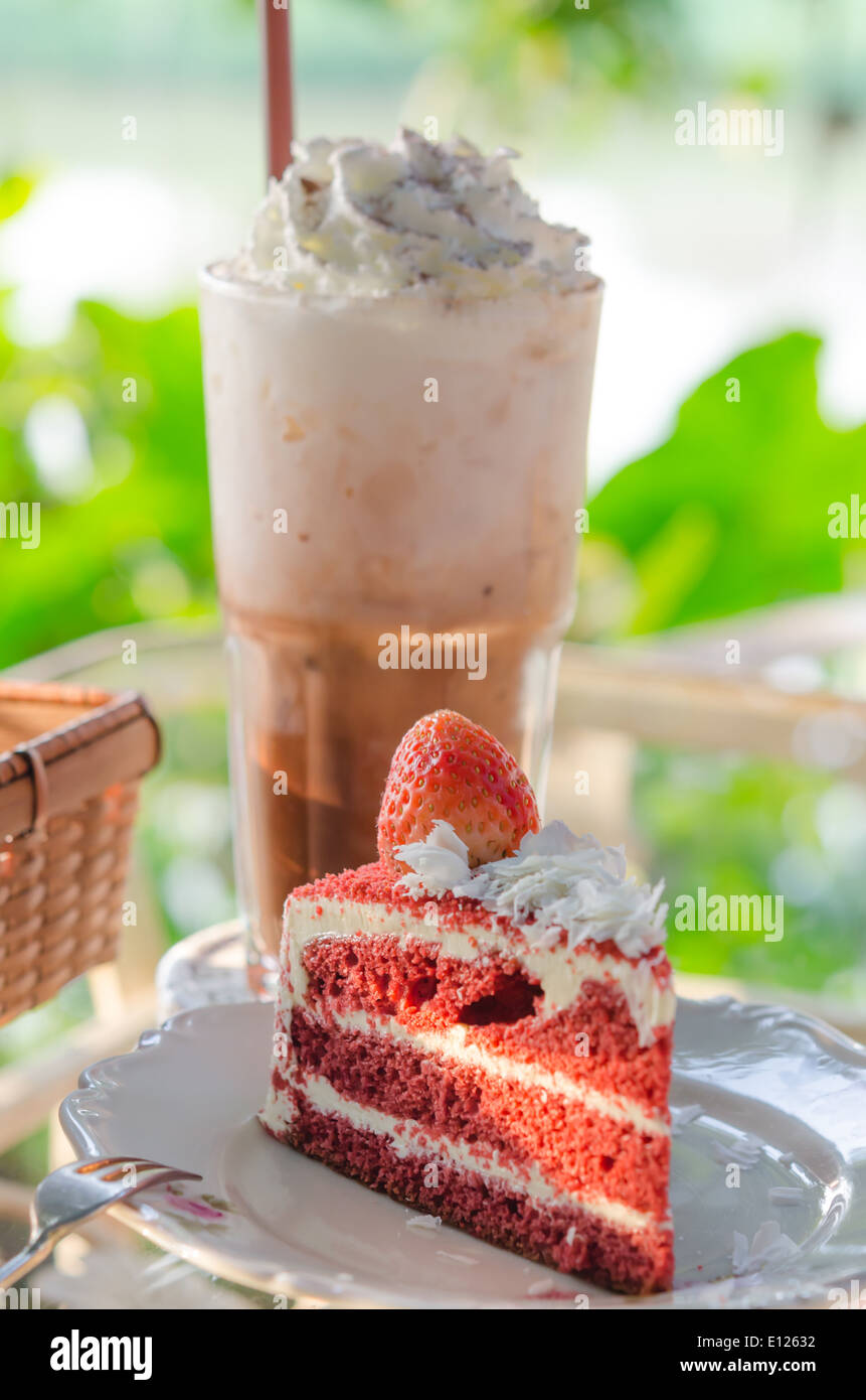 Piece of fruit cake with fresh strawberry with ice coffee Stock Photo